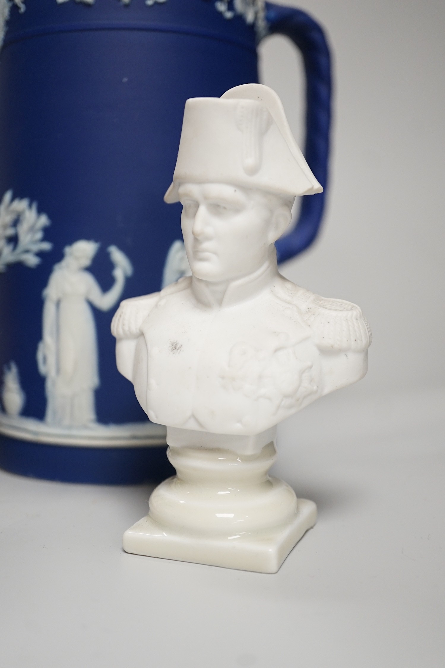 Three mid to late 19th century pieces of Wedgwood Jasperware, including a coffee pot and a small cache-pot, a pair of 19th century porcelain candlesticks converted into lamps